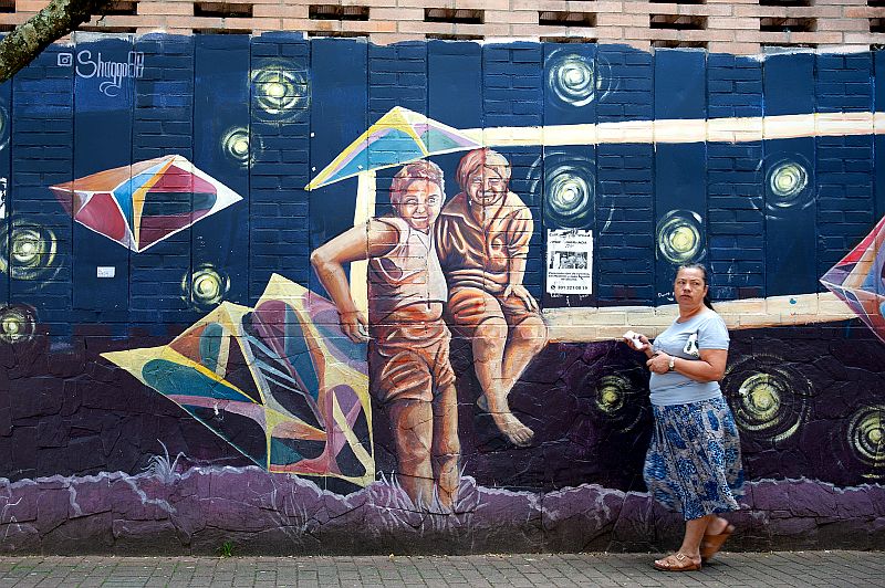 Local women of the Comuna 13 in Medellin in front of Street Art